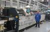 Marek Czubak, Industrial Engineering Leader at Jabil, in front of the first Ersa wave soldering machine in Jabil's electronics manufacturing facility in Kwidzyn, Poland