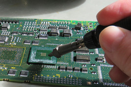 Pulling off the remaining solder with a soldering iron